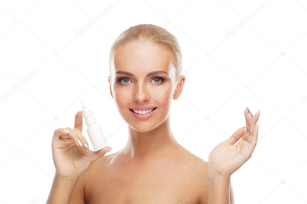 Young girl using nosal spray aerosol and drops isolated on white. Woman haveing runny nose, allergy, cold and flu illness, sinusitis and cronic disease. Healthcare and medicine concept.