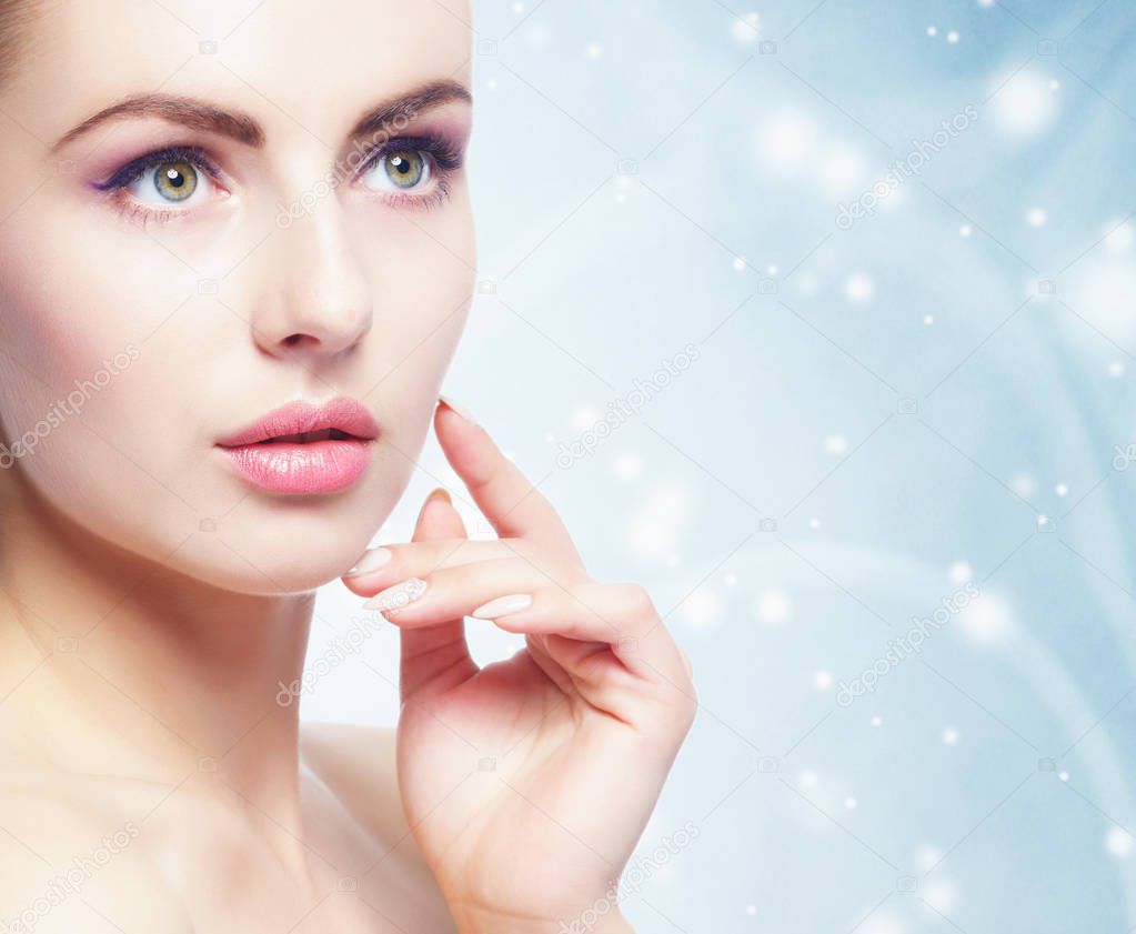Portrait of young, beautiful and healthy woman over winter Christmas background. Healthcare, spa, makeup and face lifting concept.