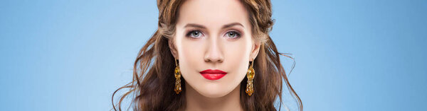 Beautiful brunette woman in luxury jewelery. Attractive young girl wearing golden jewelry.