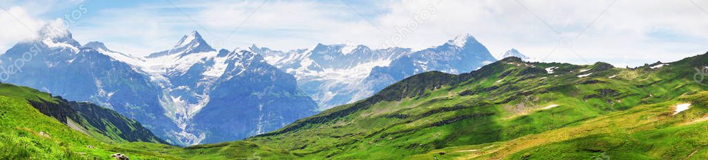Alpine peaks of Grindelwald and Jungfrau. Landscape background of Bernese highland. Alps, tourism, journey, traveling and hiking concept.