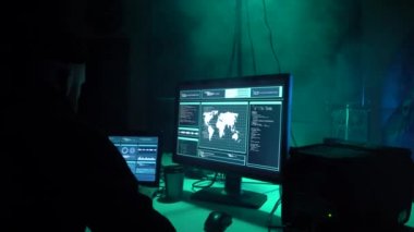 Aranan hackerlar virüs fidye yazılımını bodrumdaki bilgisayar ve dizüstü bilgisayarlarla kodluyorlar. Siber saldırı, sistem kırma ve kötü amaçlı yazılım kavramı.