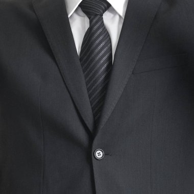 Genç ve kendinden emin iş adamı. Takım üzerinde beyaz izole iş adamı. İş kavramı yakın çekim.