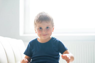 Mutlu gülümseyen çocuk portresi. Çekici çocuk evde. Gün ışığı. Nesil Z kavramı.