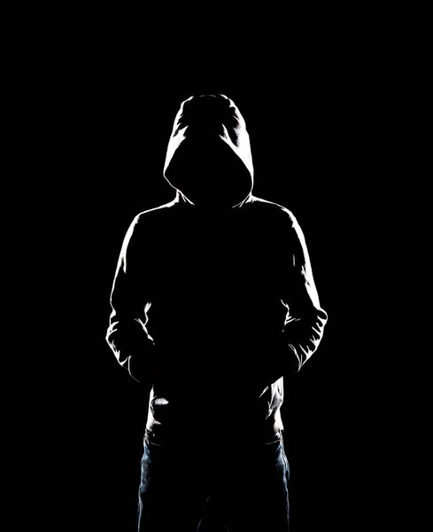 Portrait of computer hacker in hoodie. Obscured dark face. Data thief, internet fraud, darknet and cyber security concept.