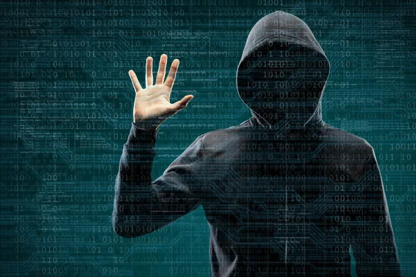 Computer hacker in mask and hoodie over abstract binary background. Obscured dark face. Data thief, internet fraud, darknet and cyber security concept.