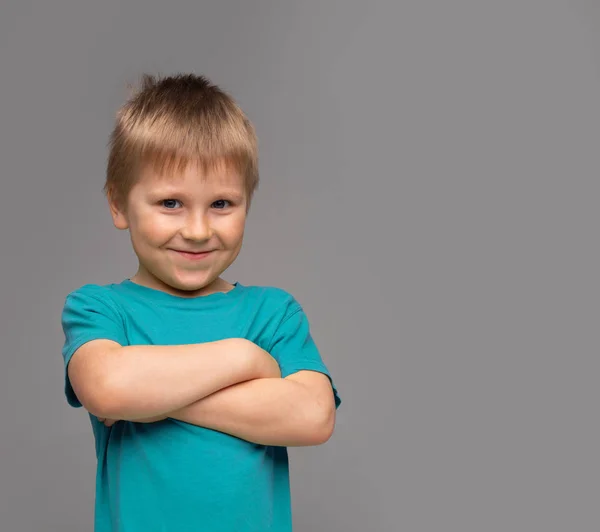 Mavi tişört mutlu gülümseyen çocuk portresi. Stüdyoda çekici çocuk. — Stok fotoğraf