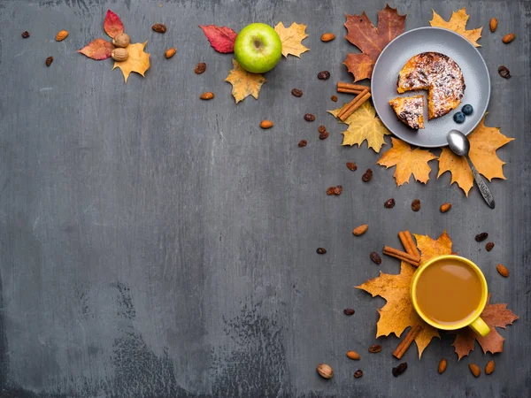 Fondo autunnale stagionale. Cornice di foglie d'acero colorate e una tazza di bevanda calda, caffè, latte o cappuccino, noce moscata, torta, mela e cannella su grigio . — Foto Stock