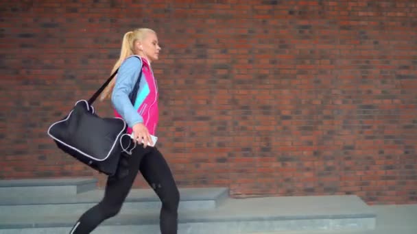 Jong Aantrekkelijk Sportief Blond Meisje Wandelen Buiten Met Een Sporttas — Stockvideo