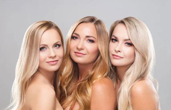 Studio portrait of young, beautiful and natural blond women over grey background. Close-up of smiling girls. Face lifting, plastic surgery, cosmetics and make-up. — Stock Photo, Image