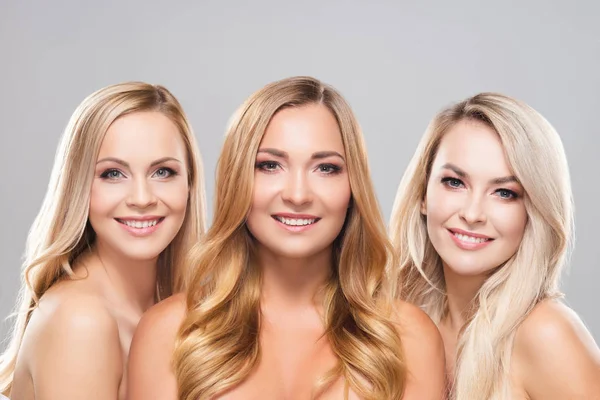 Studioporträt junger, schöner und natürlicher blonder Frauen vor grauem Hintergrund. Nahaufnahme lächelnder Mädchen. Facelifting, plastische Chirurgie, Kosmetik und Make-up. — Stockfoto