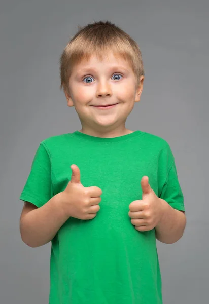 Retrato de menino sorridente feliz em camiseta verde. Miúdo atraente no estúdio. Conceito de infância . — Fotografia de Stock