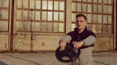 Genç ve zinde bir adam dışarıda akşam antrenmanı yapıyor. Şehir günbatımı geçmişi. Spor ve spor kavramları.