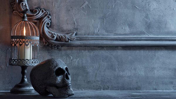Mystical Halloween still-life background. Skull, candlestick with candles, old fireplace. Horror and witchery concepts.