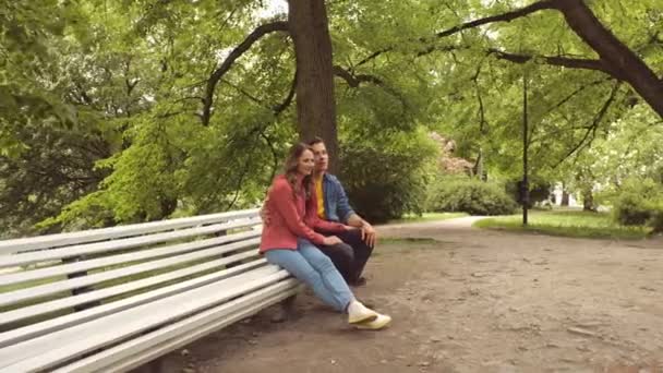 Joven Feliz Pareja Amorosa Teniendo Una Cita Banco Parque Concepto — Vídeo de stock