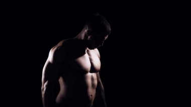 Siyah arka planda formda ve sportif vücut geliştirici. Dambıl kullanarak vücut geliştirici eğitimi. Spor ve spor kavramları.