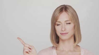 Mutlu ve etkileyici genç sarışın kadının stüdyo portresi. Neşeli, pozitif ve doğal genç kız gülümsüyor..