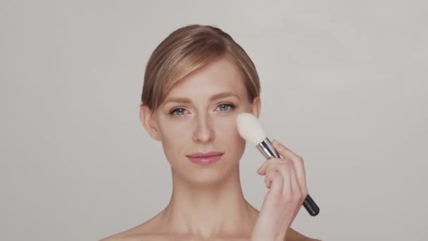 自然的金发女子应用护肤霜的工作室肖像 面部整容 化妆品及化妆概念 — 图库视频影像