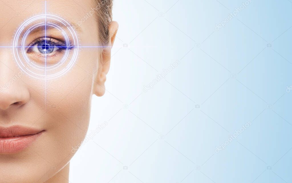 Portrait of young attractive woman with abstract laser on her eye. Medical technology concept.