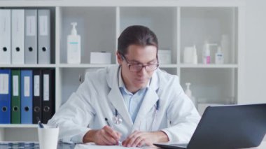 Hastane ofisinde bilgisayar kullanarak çalışan profesyonel tıp doktoru..