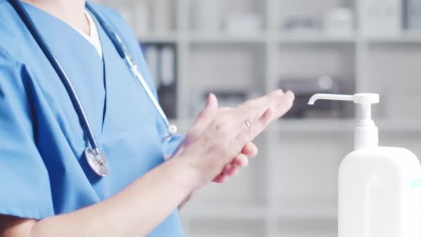 Close-up of doctor cleaning hands using disinfectant with medical soap. Office in hospital on the background. — Stock Video