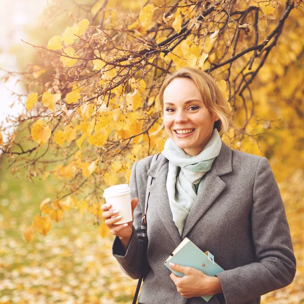 Jonge lachende vrouw in herfst park — Stockfoto