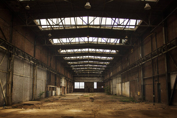 Abandoned empty old factory workshop interior with roof light