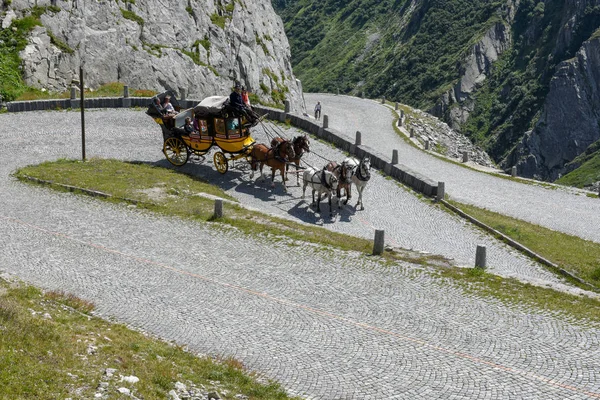 Caballo carruaje dibujado a lo largo de la antigua carretera del Monte Gotthard en el — Foto de Stock