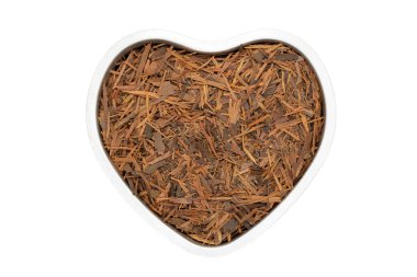 Lapacho herbal tea, heart-shaped, close up, isolated. Healthy South American tea drink used as natural antibiotic, anti-aging effect and boosts the immune system. clipart