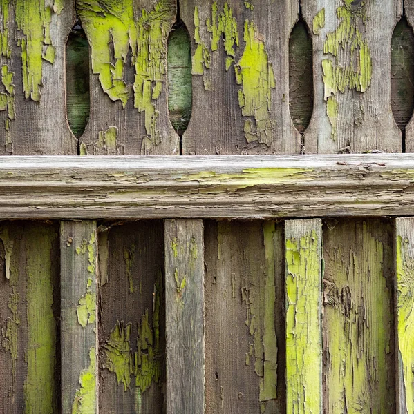 Old wooden fence soiled with peeling green paint. Abstract desig — Stock Photo, Image