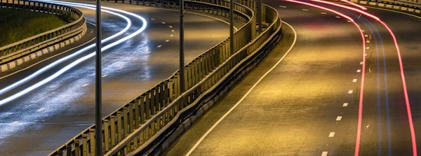 Road car light streaks. Night light painting stripes. Long expos