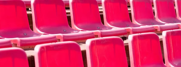 Stadium seats, red color. Soccer, football or baseball stadium t — Stock Photo, Image