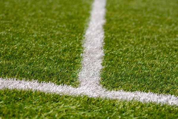 Texture of artificial grass herb cover sports field. It is used