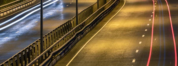 Road car light streaks. Night light painting stripes. Long expos