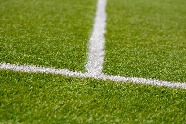 Texture of artificial grass herb cover sports field. It is used