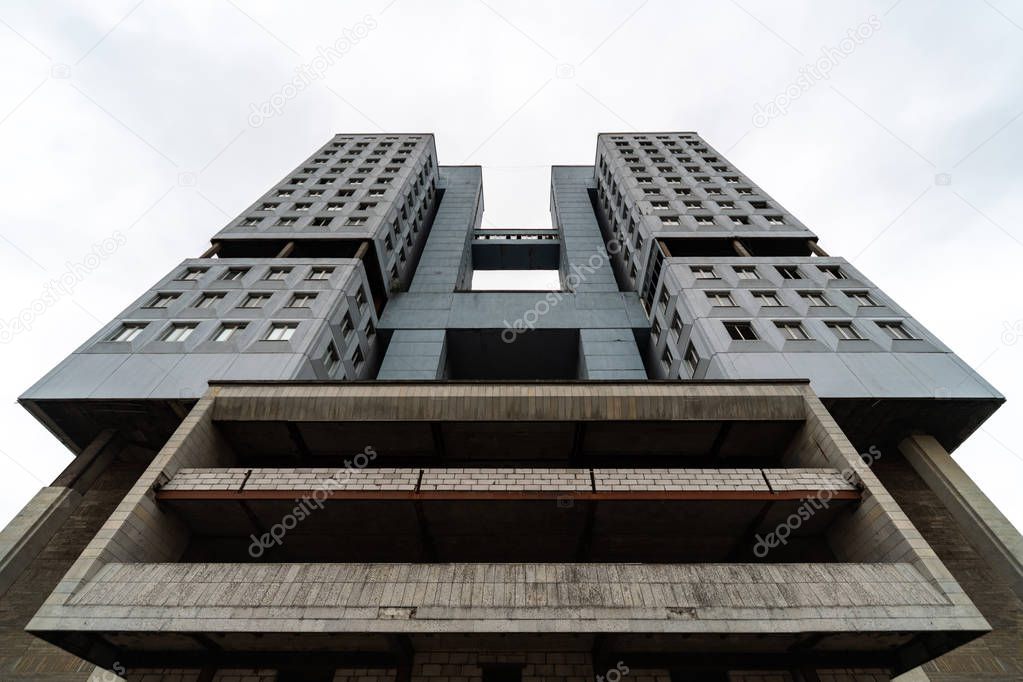 Abandoned high-rise building, cloudy weather, copy space. Unfinished shell construction. House of Soviets in Kaliningrad, Russia.