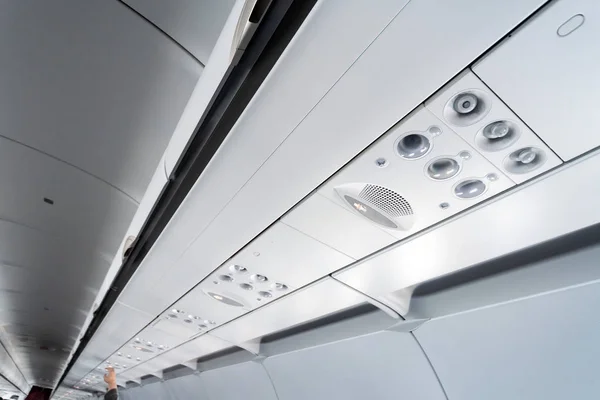 Airplane air conditioning control panel over seats. Stuffy air in aircraft cabin with people. New low-cost airline. — Stock Photo, Image