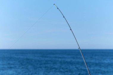 Mavi okyanus veya deniz arka plan karşı Olta, kopya alanı. En büyük vurgunu bekliyorum. Meditative dinlenmek spor.