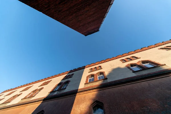 Old barracks building and boiler room pipe, perspective bottom view. Historic building from the last world war II