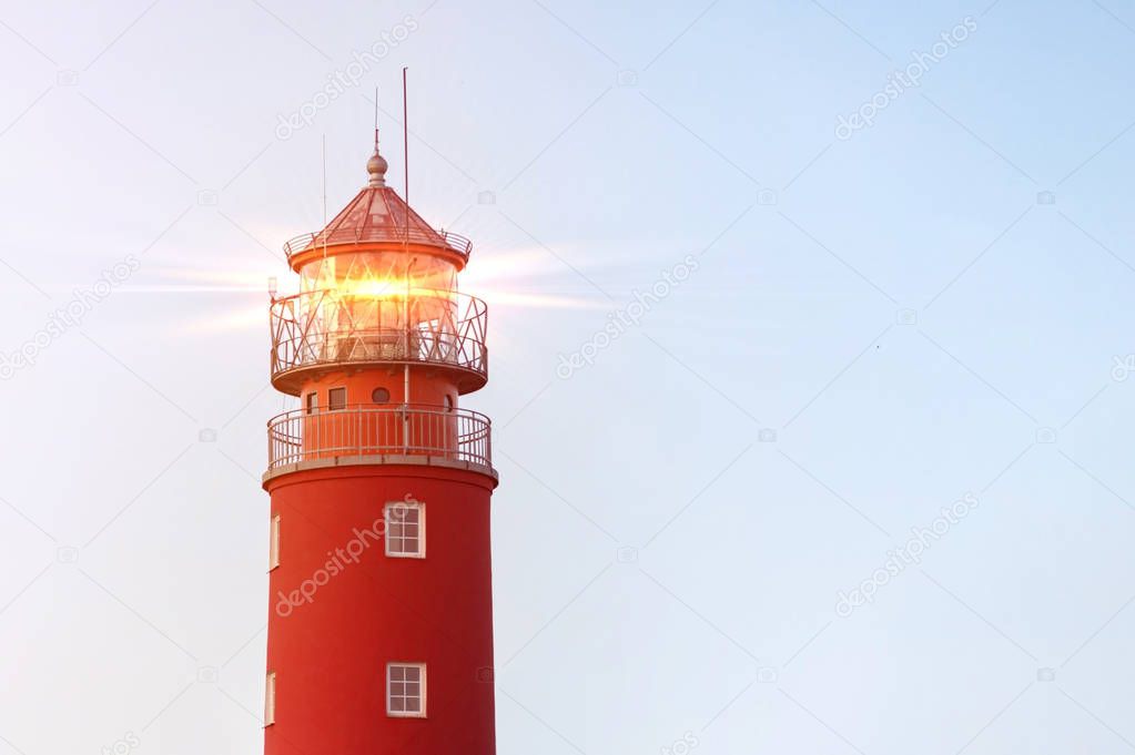Lighthouse in Baltiysk port. Beautiful rainbow and beacon lights. Clean blue sky, copy space.