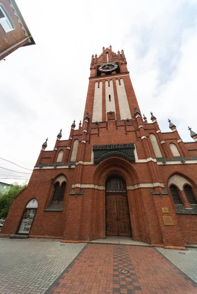 Catholic church of Holy Family in Russia, Kaliningrad city. Neogothic red brick building style. Inscription \