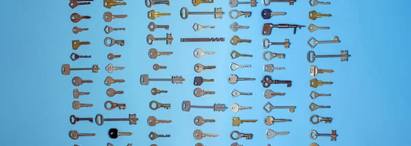 Keys set on blue background. Door lock keys and safes for property security and house protection. Different antique and new types of keys. — Stock Photo, Image