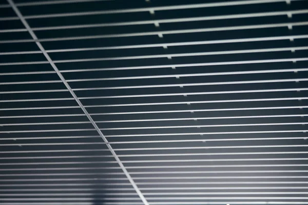 Office grille ceiling. Modern black metal grille ceiling, suspended covering. Abstract design texture.