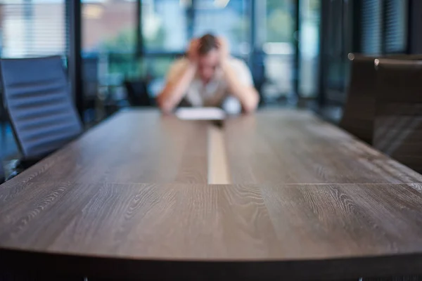 Fired employee in conference room. Manager at table in modern meeting room for business negotiations and business meetings.