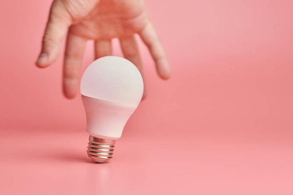 Light bulb and hand, idea catching concept. Symbol of new events or finding solutions to problems. Creative minimal innovations.