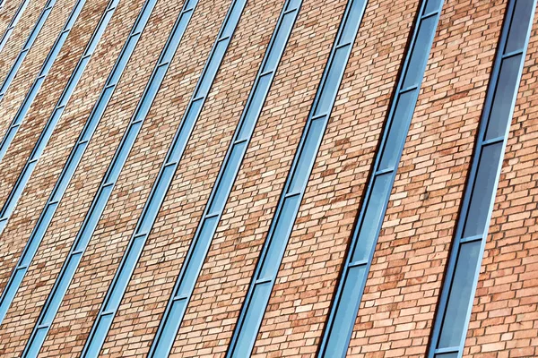 Multistorey building. Rhythm in photography. Multi-storey facade, windows and block of flats, close up. Modern apartments in high raised building. Angle perspective.