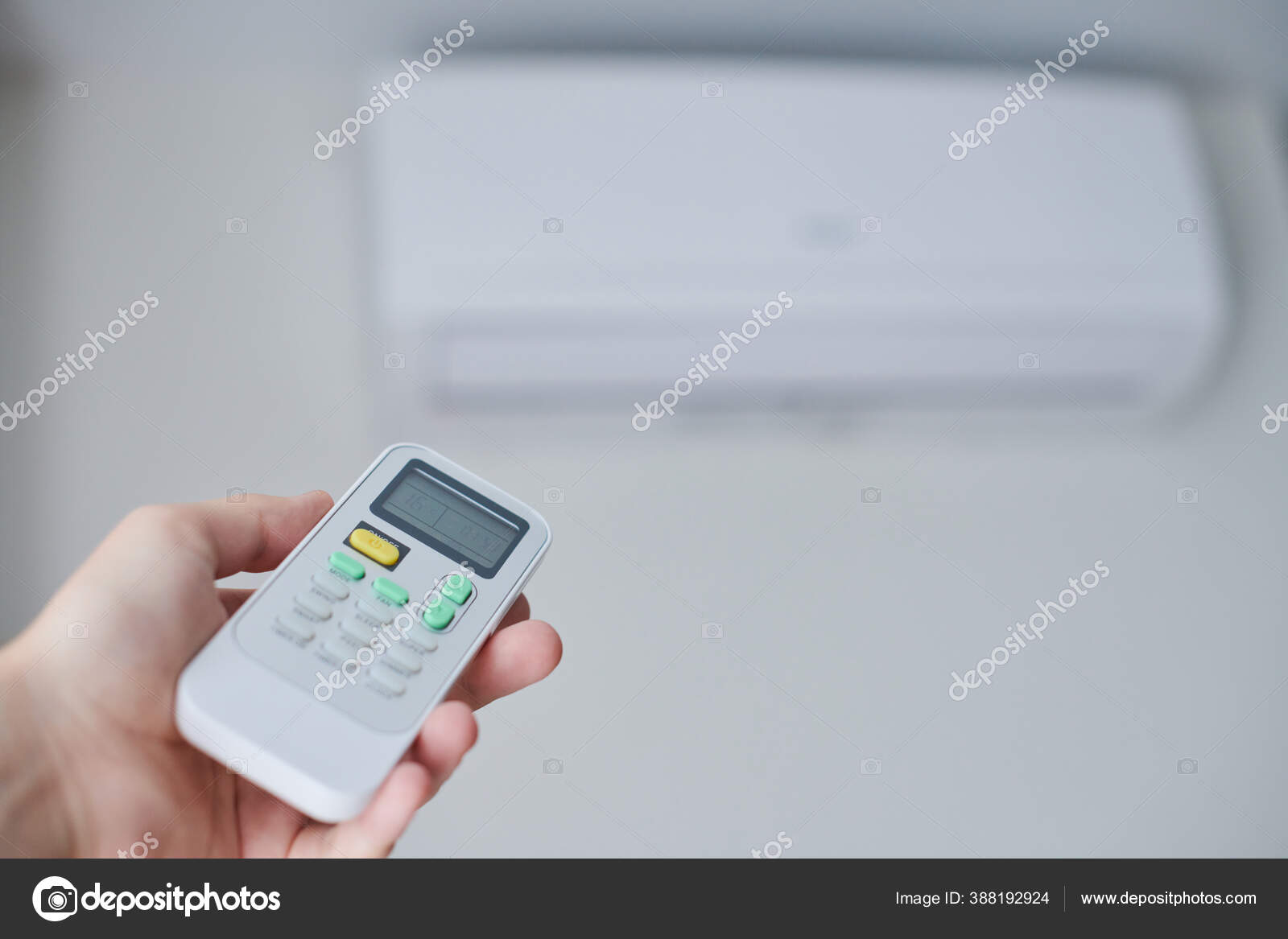 Remote control for air conditioner in hand. Stock Photo by ©travelarium