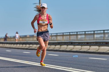 Voronezh, Rusya - 24.08.2019 - Genç kız yol boyunca koşar. Koşu maratonu ve şampiyonluk yarışması, fotokopi alanı. Sokak dışarı koşuyor. Sağlıklı spor etkinliği.