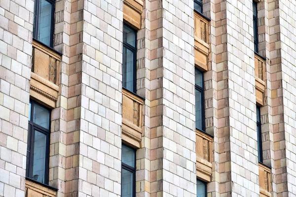 Multistorey building. Rhythm in photography. Multi-storey facade, windows and block of flats, close up. Modern apartments in high raised building. Angle perspective.