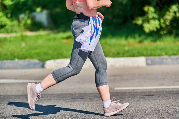 Running woman. Fitness woman jogging in sportswear on city road. Healthy lifestyle, sport hobby. Street workout, sprinting outdoor