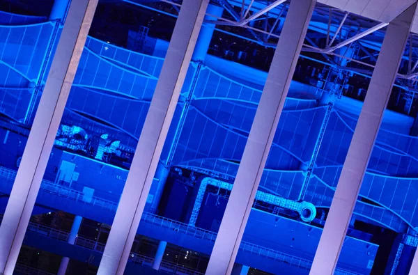 Stadium night lights, close up. Blue lighting of sports facility. Football stadium building at night. Blue design background